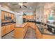 Well-equipped kitchen with granite counters, wood cabinets, and modern appliances at 7730 Brambly Creek Ct, Las Vegas, NV 89129