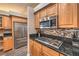 Modern kitchen featuring stainless steel appliances and granite countertops at 7730 Brambly Creek Ct, Las Vegas, NV 89129
