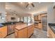 Open-concept kitchen with island, stainless appliances, and seamless flow to the living area at 7730 Brambly Creek Ct, Las Vegas, NV 89129