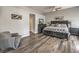 Spacious main bedroom featuring wood floors, ceiling fan, and a sitting area at 7730 Brambly Creek Ct, Las Vegas, NV 89129