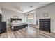 Bright main bedroom features a bay window with seating and wood floors at 7730 Brambly Creek Ct, Las Vegas, NV 89129