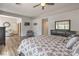 Spacious main bedroom boasts wood floors, ceiling fan, tv, and neutral paint at 7730 Brambly Creek Ct, Las Vegas, NV 89129