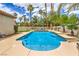 Refreshing pool featuring step-down entry, framed by elegant palm trees and desert flora for a tranquil oasis feel at 7730 Brambly Creek Ct, Las Vegas, NV 89129