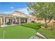 Spacious backyard featuring artificial grass, putting green, patio and plenty of space for recreation at 7929 Ben Hogan Dr, Las Vegas, NV 89149