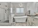Bright bathroom featuring a modern tub, glass-enclosed shower, and elegant finishes at 7929 Ben Hogan Dr, Las Vegas, NV 89149