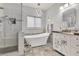 Bright bathroom featuring a modern tub, glass-enclosed shower, and elegant finishes at 7929 Ben Hogan Dr, Las Vegas, NV 89149