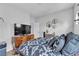 Comfortable bedroom with a wooden dresser, and a decorative accent wall at 7929 Ben Hogan Dr, Las Vegas, NV 89149