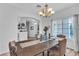 Bright dining room boasts a chandelier, large windows, and an archway to another room at 7929 Ben Hogan Dr, Las Vegas, NV 89149