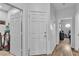 Hallway with neutral walls and wood-look floors, leading to various rooms in the home at 7929 Ben Hogan Dr, Las Vegas, NV 89149