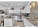 Bright kitchen boasts white cabinetry, granite countertops, stainless steel appliances and a kitchen island at 7929 Ben Hogan Dr, Las Vegas, NV 89149
