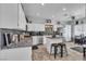 Bright kitchen boasts white cabinetry, granite countertops, stainless steel appliances and a kitchen island at 7929 Ben Hogan Dr, Las Vegas, NV 89149
