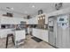 Bright kitchen boasts white cabinetry, granite countertops, stainless steel appliances and a kitchen island at 7929 Ben Hogan Dr, Las Vegas, NV 89149