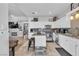 Charming kitchen with white cabinetry, granite countertops, island and modern appliances at 7929 Ben Hogan Dr, Las Vegas, NV 89149