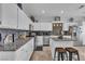 Bright kitchen boasts white cabinetry, granite countertops, stainless steel appliances and a kitchen island at 7929 Ben Hogan Dr, Las Vegas, NV 89149