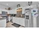Bright kitchen boasts white cabinetry, granite countertops, stainless steel appliances and a kitchen island at 7929 Ben Hogan Dr, Las Vegas, NV 89149