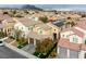Neighborhood aerial view featuring desert landscaping, mountain views, tile roofs, and solar panels at 852 Colina Alta Pl, Las Vegas, NV 89138