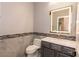 Stylish half bathroom featuring a modern vanity with illuminated mirror and decorative tile backsplash at 852 Colina Alta Pl, Las Vegas, NV 89138