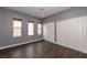 Bedroom with hardwood floors, closet doors and natural light from the windows at 852 Colina Alta Pl, Las Vegas, NV 89138
