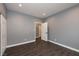 Bedroom with modern gray walls, white trim, dark wood floors, and closet with sliding doors at 852 Colina Alta Pl, Las Vegas, NV 89138