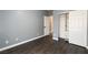 Bedroom boasts gray walls, dark wood floors, open closet, and white trim at 852 Colina Alta Pl, Las Vegas, NV 89138