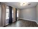 A bedroom with custom curtains, neutral walls and hard wood flooring at 852 Colina Alta Pl, Las Vegas, NV 89138