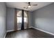 Bedroom featuring dark wood floors, gray walls, modern curtains and a view outside at 852 Colina Alta Pl, Las Vegas, NV 89138