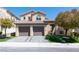Charming two-story home featuring a tile roof, well-maintained landscaping, and a spacious two-car garage at 852 Colina Alta Pl, Las Vegas, NV 89138