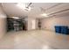 Spacious garage with storage racks, water heater, and ample room for parking at 852 Colina Alta Pl, Las Vegas, NV 89138