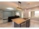 Open kitchen with stainless steel appliances, granite countertops, island and views to living room at 852 Colina Alta Pl, Las Vegas, NV 89138