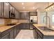 Stylish kitchen featuring gray cabinets, stainless steel appliances, and granite countertops at 852 Colina Alta Pl, Las Vegas, NV 89138