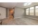 Open living area with tiled floors, large windows, and an entry view to the stairway and front door at 852 Colina Alta Pl, Las Vegas, NV 89138