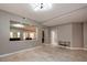 Open living space with gray tile flooring and a pass-through window connecting to another living area at 852 Colina Alta Pl, Las Vegas, NV 89138