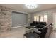 Inviting living room featuring a decorative stone accent wall and comfortable black leather seating at 852 Colina Alta Pl, Las Vegas, NV 89138