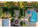 Aerial view of a home's backyard with pool, water feature, landscaping, and patios at 8620 W La Madre Way, Las Vegas, NV 89149