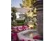 Close up of water feature, Roses and lush landscaping in backyard at 8620 W La Madre Way, Las Vegas, NV 89149