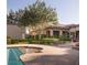 The home has a large patio surrounding the pool and beautiful backyard with mature landscaping at 8620 W La Madre Way, Las Vegas, NV 89149