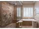 Spa-like bathroom with a soaking tub and luxurious walk-in shower at 8620 W La Madre Way, Las Vegas, NV 89149