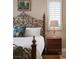 Cozy bedroom with ornate wrought iron headboard and traditional decor at 8620 W La Madre Way, Las Vegas, NV 89149