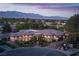 Beautiful single-story home featuring lush landscaping, stone accents, and a circular driveway with mountain views at 8620 W La Madre Way, Las Vegas, NV 89149
