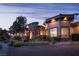 Elegant home featuring a stone entryway and beautifully landscaped front yard at 8620 W La Madre Way, Las Vegas, NV 89149