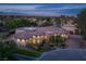 Beautiful single-story home featuring lush landscaping, stone accents, and a circular driveway with mountain views at 8620 W La Madre Way, Las Vegas, NV 89149