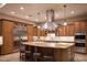 Gourmet kitchen with stainless steel appliances, ample counter space, and a center island with seating at 8620 W La Madre Way, Las Vegas, NV 89149