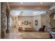 Bright living area featuring a stone archway, beautiful hardwood floors, and neutral decor at 8620 W La Madre Way, Las Vegas, NV 89149