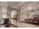 Open-concept living space with stone archways, hardwood floors, and tray ceilings, and lots of light at 8620 W La Madre Way, Las Vegas, NV 89149