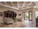 Comfortable living room featuring a coffered ceiling, a view of the back patio, and tile flooring at 8620 W La Madre Way, Las Vegas, NV 89149