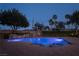 Sparkling pool with a stone waterfall feature and lush landscaping at 8620 W La Madre Way, Las Vegas, NV 89149