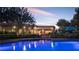 Beautiful pool area with seating and lush landscaping at dusk at 8620 W La Madre Way, Las Vegas, NV 89149