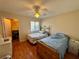 Cozy bedroom with two beds, wood floors, ceiling fan, and closet at 950 Seven Hills Dr # 2014, Henderson, NV 89052