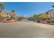 Exterior shot of the community gate with trees, landscaping, and well-maintained asphalt at 950 Seven Hills Dr # 2014, Henderson, NV 89052