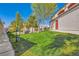 Community lawn with green space, trash receptacle, trees, and lush green grass at 950 Seven Hills Dr # 2014, Henderson, NV 89052